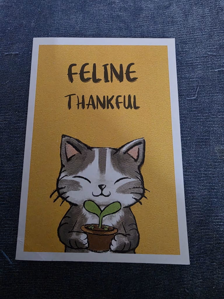 Thank you card with a cat on it carrying a wee plant